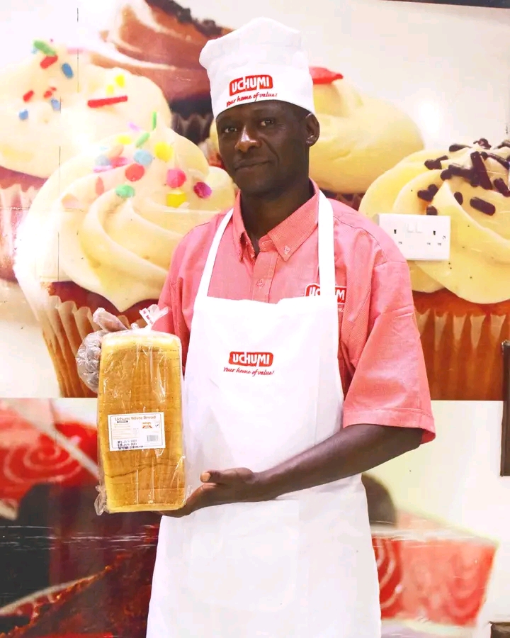 Uchumi Supermarkets chef holding Uchumi branded bread